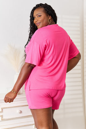 Model showcasing a pink Basic Bae full-size rayon half sleeve top and shorts set, perfect for casual outings.