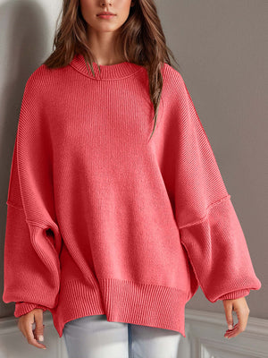 Chic side-slit sweater in coral with cozy round neck, perfect for winter style and comfort.