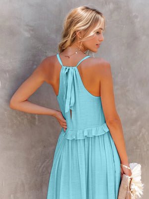 Ruffled sleeveless tiered maxi dress in blue with a tied back detail, showcasing elegant summer style.
