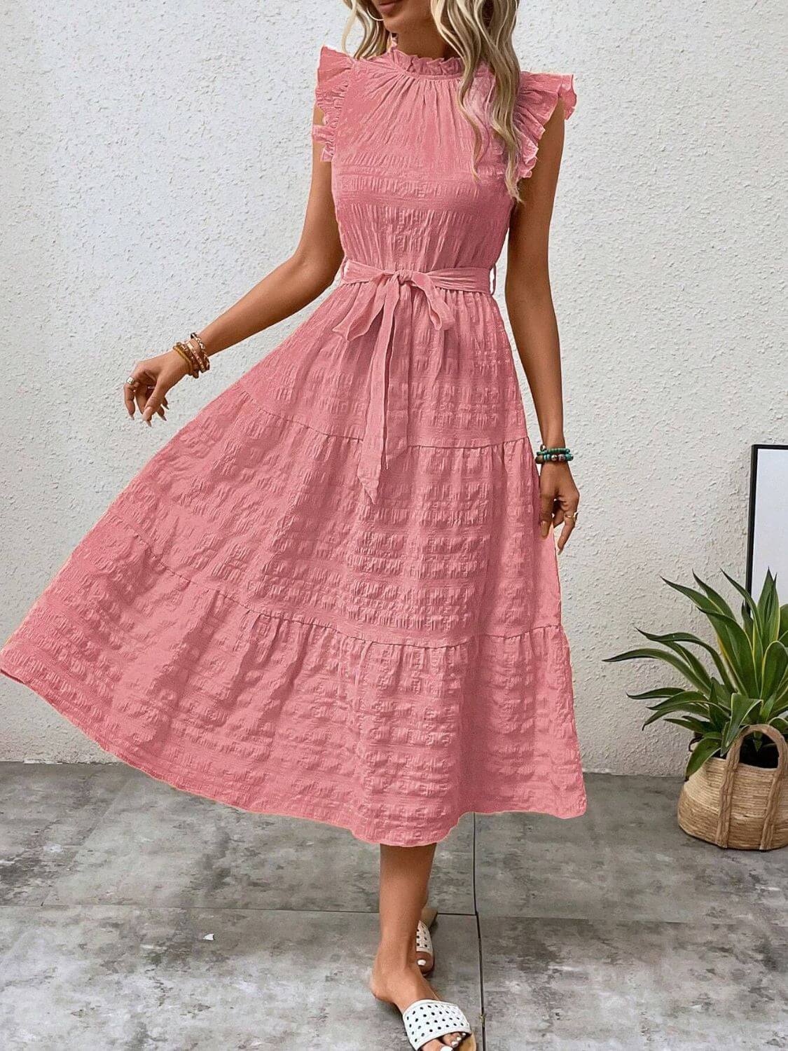 Tied ruffled cap sleeve midi dress in pink, showcasing sheer detailing and a flattering silhouette.