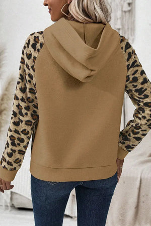 Back view of leopard half button long sleeve hoodie with a tan body and leopard print sleeves.