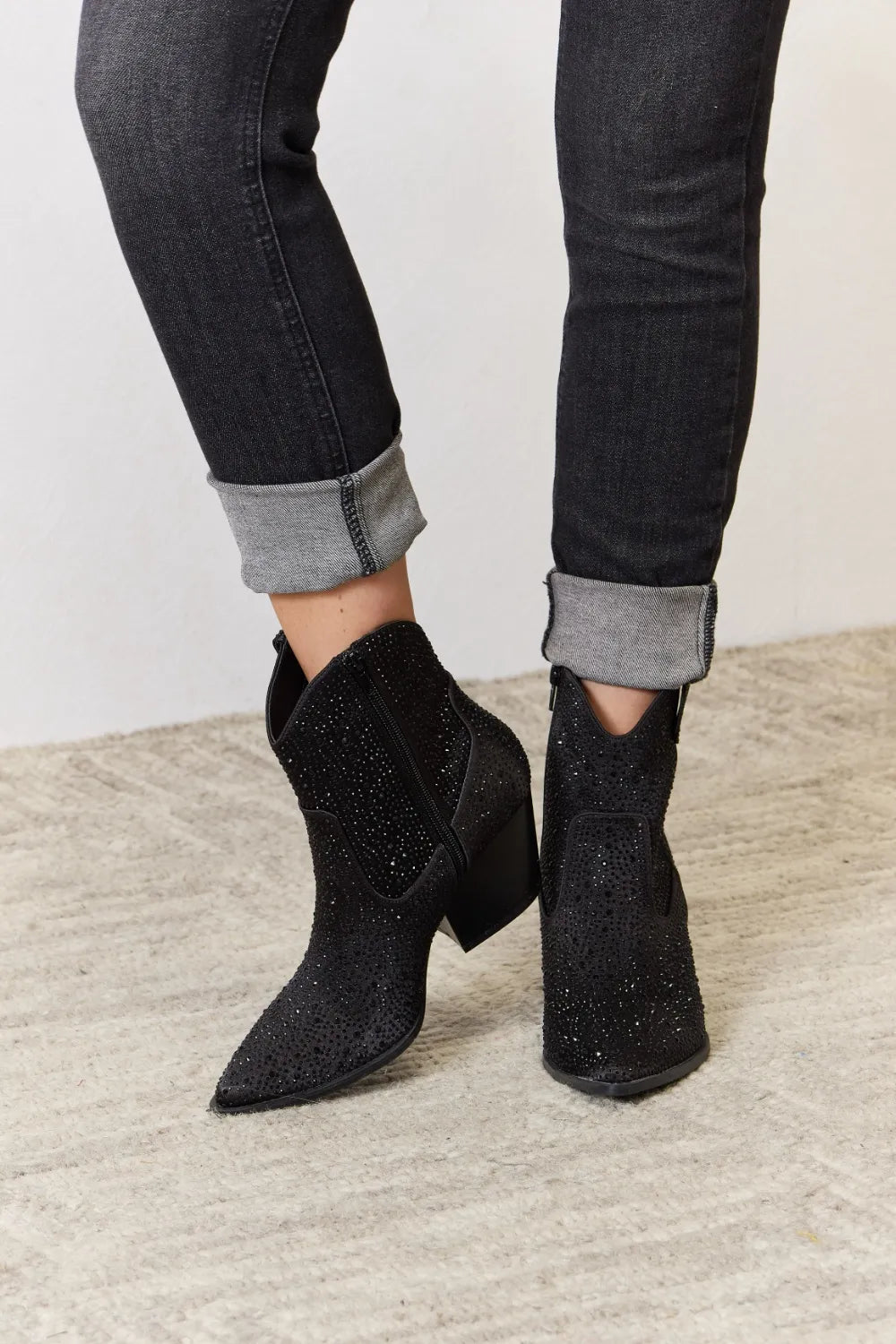 East Lion Corp Rhinestone Ankle Cowboy Boots worn with rolled jeans, showcasing stylish ankle height and embellishments.