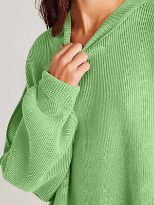 Cozy green sweater featuring a ribbed texture and relaxed fit, perfect for a stylish winter look.