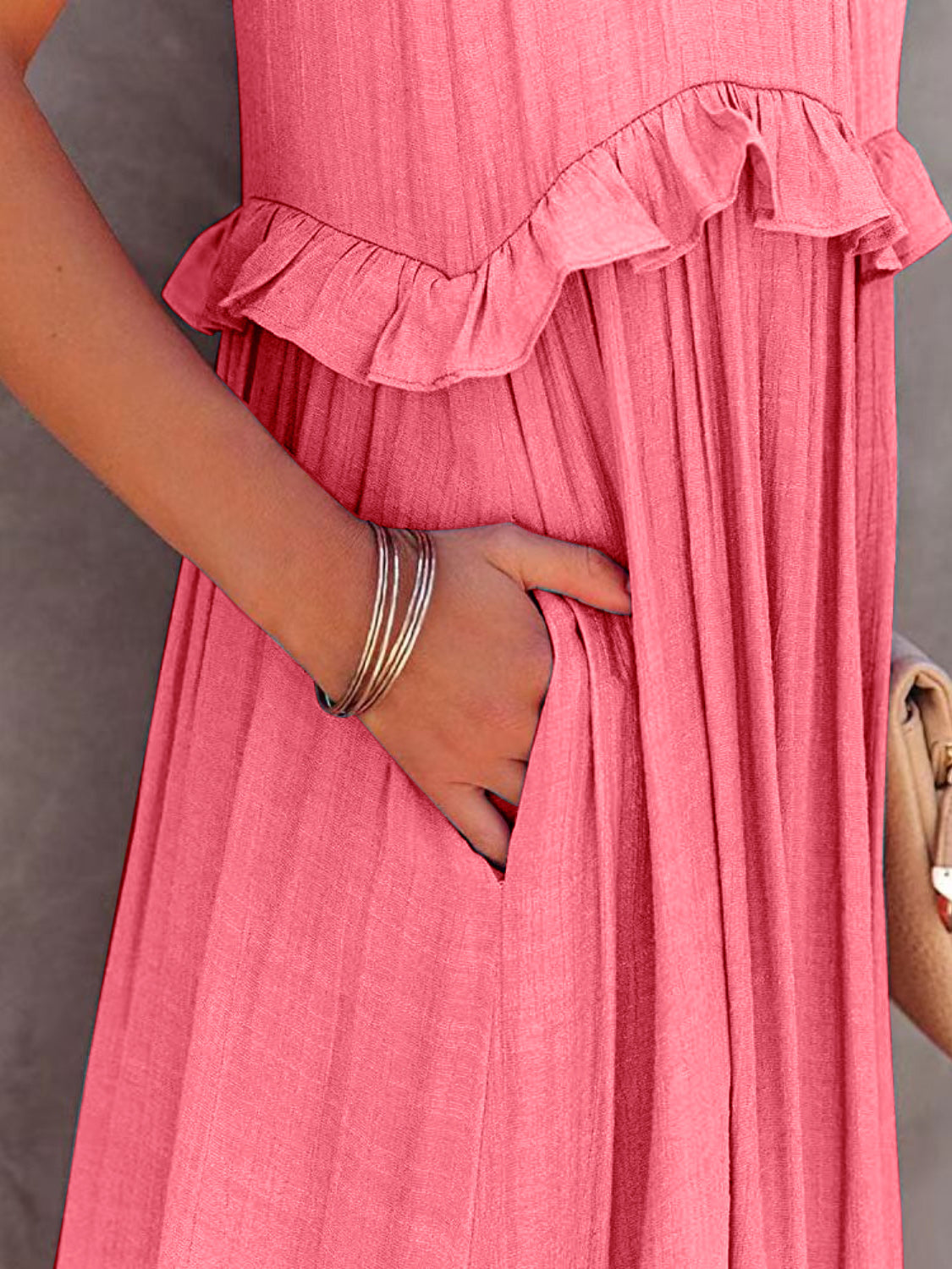 Close-up of a ruffled sleeveless tiered maxi dress in pink with pockets, showcasing the soft fabric and detailed ruffles.