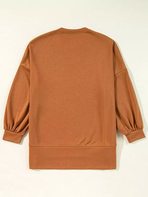 Back view of a brown Halloween graphic long sleeve loose top with balloon sleeves and a relaxed fit.