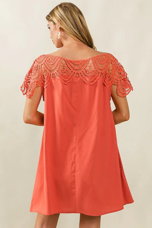 Back view of a coral BiBi Crochet Lace Yoke dress showcasing intricate lace detailing on the shoulders.