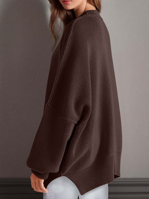 Model wearing a chic brown side-slit sweater with a cozy round neck, showcasing its relaxed fit and comfort.