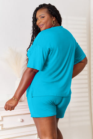 Model showcasing back view of Basic Bae full size soft rayon half sleeve top and shorts set in turquoise.