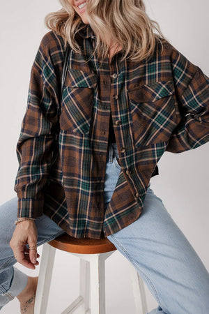 Model wearing a plaid button-up long sleeve jacket with pockets, styled with light blue jeans.
