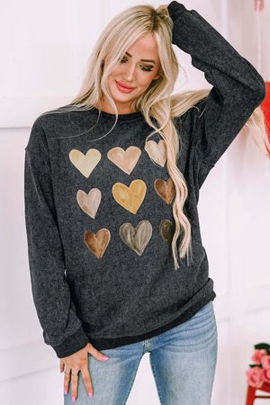 Heart round neck dropped shoulder sweatshirt in black with colorful heart prints, perfect for casual wear.