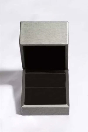 Elegant open jewelry box for storing 2 carat moissanite earrings, featuring a sleek silver design.