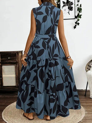 Back view of a Printed Tie Waist Sleeveless Maxi Dress with a leaf pattern in blue and black, perfect for summer outings.