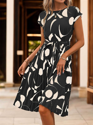 Elegant Tied Pleated Printed Cap Sleeve Dress in black and white, perfect for casual outings or special occasions.