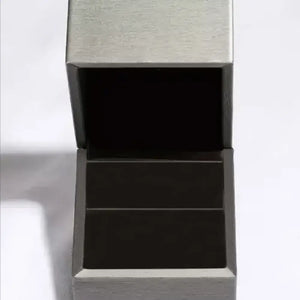 Open silver jewelry box showcasing a dark interior, perfect for storing rings and accessories.