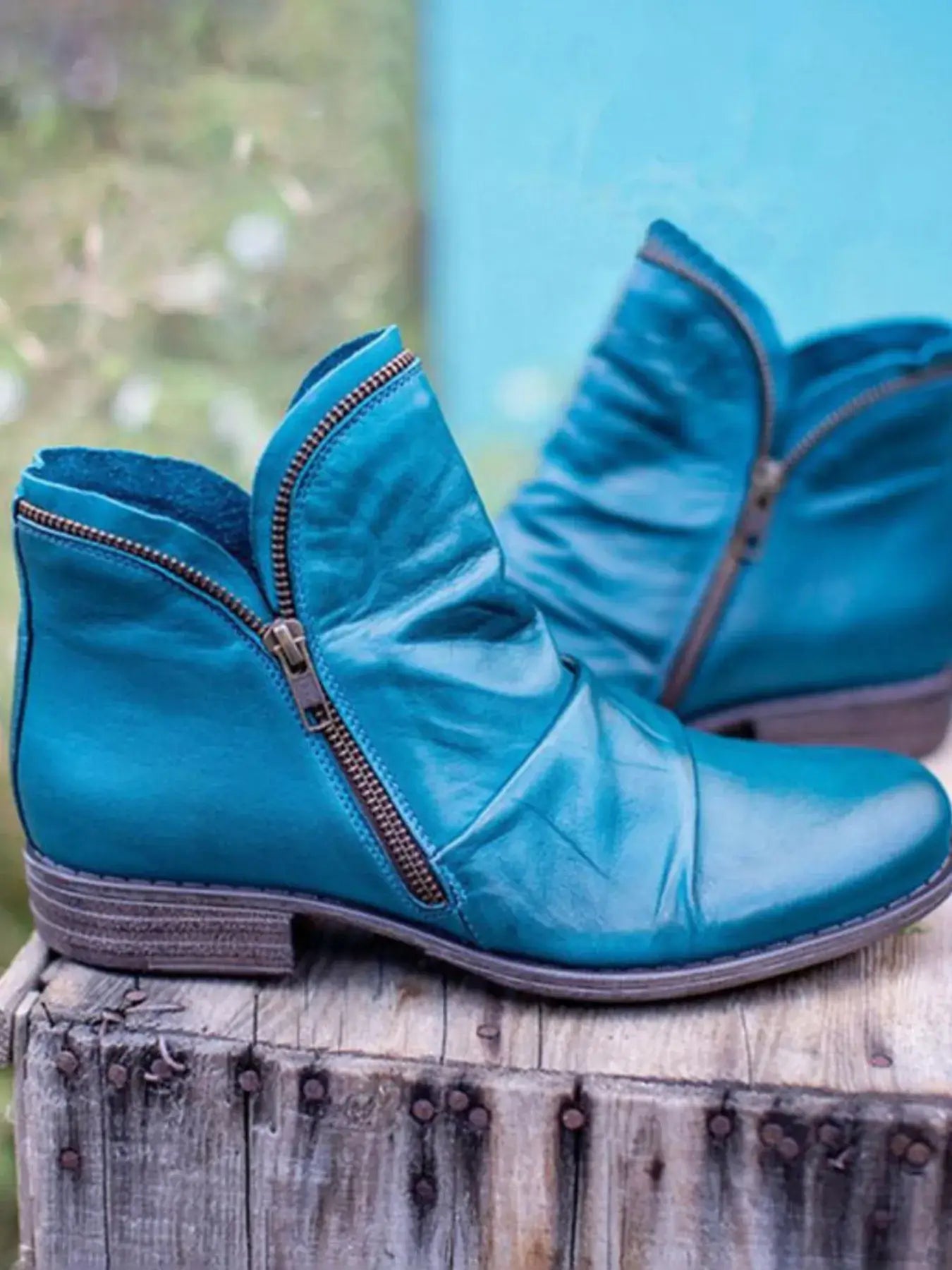 Stylish turquoise round toe block heel boots with zipper detail, perfect for a chic casual look.