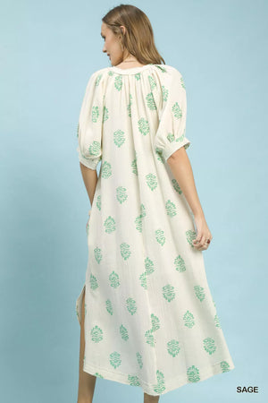 Umgee Printed Cotton Gauze Midi Dress showcasing its floral pattern and breezy design from the back on a model.