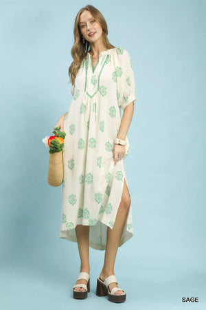 Umgee Printed Cotton Gauze Midi Dress featuring a split neckline, tassel ties, and stylish side slits.