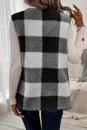 Back view of a plaid Sherpa vest coat in black and white, styled over a long-sleeve top.