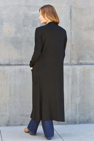 Model wearing Basic Bae Full Size Open Front Long Sleeve Cover Up, showcasing its sleek design and back view.