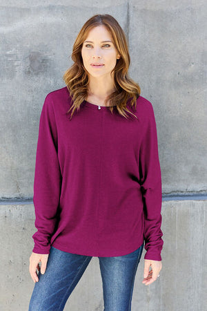 Model wearing a purple Double Take full-size round neck long sleeve t-shirt paired with jeans.