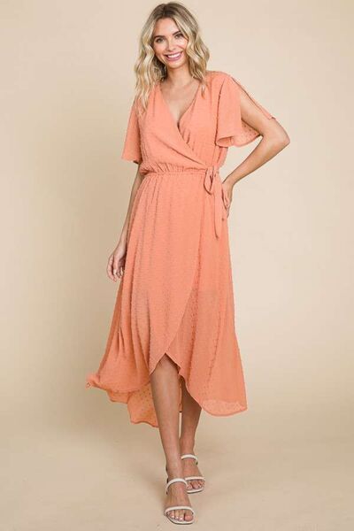 Chic Swiss Dot Dress in coral orange with ruffled sleeves, perfect for elegant occasions. Available in full sizes for a comfortable fit.