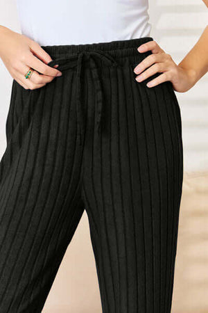 Close-up of black ribbed pants featuring a drawstring waist, part of the Basic Bae cozy chic set.