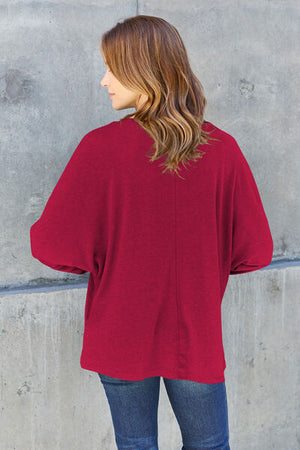 Model wearing a maroon double take long sleeve T-shirt, showcasing a stylish round neck and relaxed fit from the back.