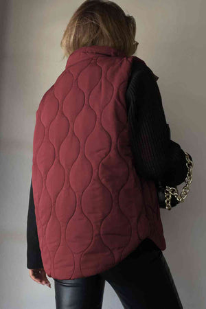 Back view of a collared neck vest in burgundy, featuring quilted design and a relaxed fit with pockets.