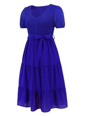 Smocked tie front tiered dress in deep blue with short sleeves and a comfortable fit, perfect for casual outings.