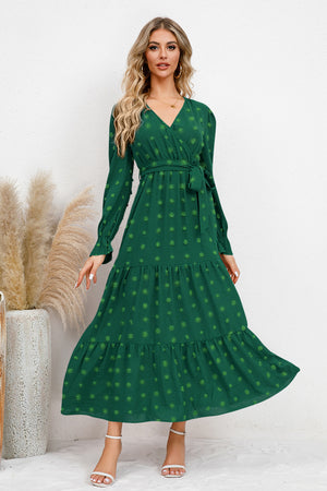 Green Swiss dot tied surplice flounce sleeve dress with a flattering fit, perfect for casual events and gatherings.