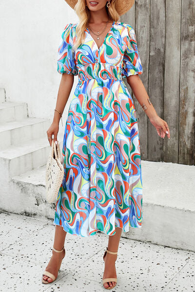Smocked printed V-neck short sleeve dress with colorful swirls, perfect for summer outings.