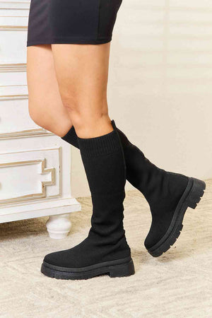 WILD DIVA knee high platform sock boots in black, featuring a stylish snug fit and chunky sole for chic comfort.