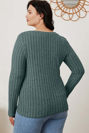 Rear view of a model wearing a ribbed green long sleeve T-shirt with a relaxed fit.