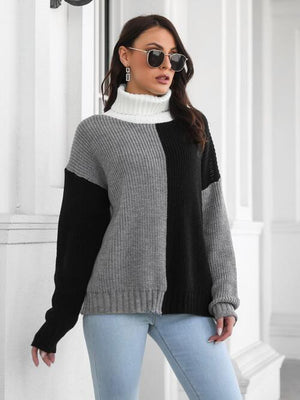 Stylish contrast turtleneck long sleeve sweater in black, gray, and white with casual jeans, perfect for a modern look.