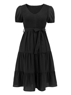 Smocked tie front short sleeve tiered dress in black, featuring a flattering silhouette and elegant design.