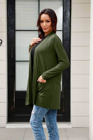 Model wearing Basic Bae full size long sleeve cardigan with pockets in olive green, styled with jeans.