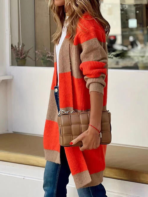 Stylish woman wearing a contrast open front long sleeve cardigan in orange and brown, paired with jeans and a handbag.