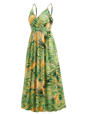 Printed surplice spaghetti strap dress in green and yellow tropical palm leaf design, perfect for summer outings.