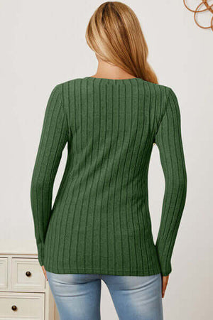 Back view of a woman wearing a green ribbed long sleeve t-shirt, showcasing a stylish and comfortable design.