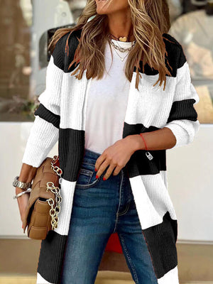 Stylish woman in a contrast open front long sleeve cardigan, paired with jeans and a handbag, exuding casual elegance.