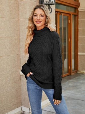 Model wearing a stylish black cable-knit mock neck sweater paired with jeans, showcasing a cozy autumn look.