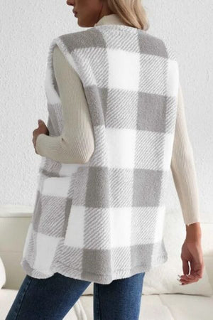 Back view of a Sherpa plaid open front vest coat in white and gray, styled with a long sleeve top and jeans.