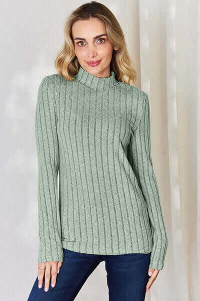 Model wearing Basic Bae ribbed mock neck long sleeve t-shirt in green, showcasing its stylish and comfortable design.