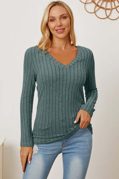 Model wearing a Basic Bae full-size ribbed v-neck long sleeve t-shirt in teal with jeans.