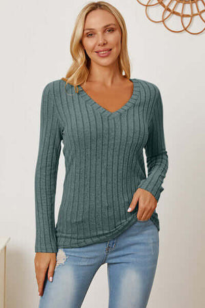 Model wearing a Basic Bae full-size ribbed v-neck long sleeve t-shirt in teal with jeans.