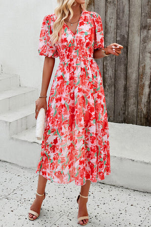Bright floral smocked V-neck short sleeve dress with puff sleeves, perfect for summer occasions.