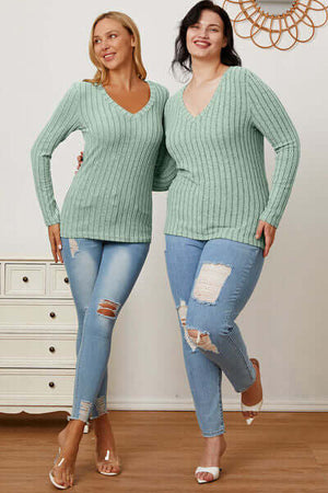 Two models wearing Basic Bae ribbed long sleeve V-neck t-shirts in mint, paired with ripped jeans.
