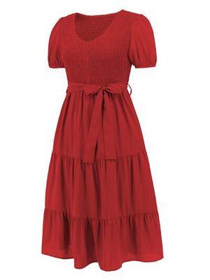 Red smocked tie front short sleeve tiered dress with a flattering silhouette and feminine design.