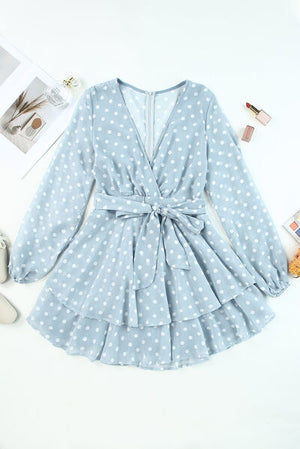 Blue polka dot balloon sleeve dress with tied waist and layered skirt, featuring a stylish V-neck design.