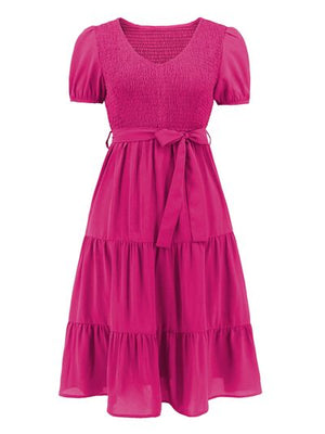 Vibrant pink smocked tie front short sleeve tiered dress, perfect for casual outings or summer gatherings.
